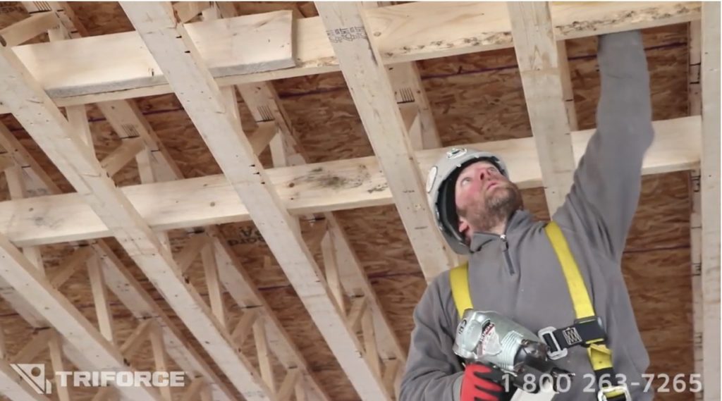 Floor system with joists installed by worker