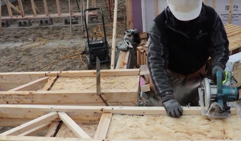 Worker cutting a joist on the job site